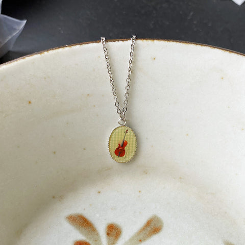 LAVISHY cute & dainty rhodium plated violin necklace. Fun to wear, playful gift for family & friends who love music.  Wholesale at www.lavishy.com