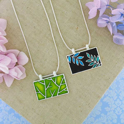 Online shopping for LAVISHY's handmade silver plated reversible pendant necklace with colorful tree branch & leaf enamel enamel motifs. Great for everyday wear & lovely gift for friends & family. Wholesale at www.lavishy.com for gift shops, clothing & fashion accessories boutiques in Canada, USA & worldwide since 2001.