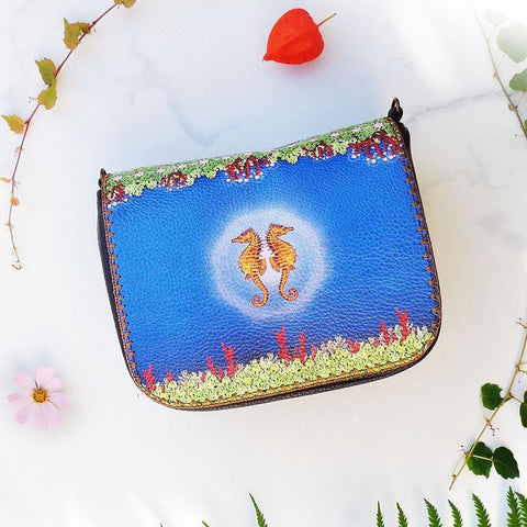 Mlavi's Eco-friendly vegan leather crossbody bag with whimsical seahorse lovers print. It's great for everyday use & a unique gift for yourself, family & friends. More ocean theme fashion accessories are available for wholesale at www.mlavi.com for gift & boutique buyers worldwide.