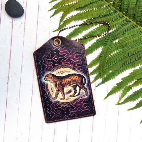 Mlavi vegan leather vintage style luggage tag features Tiger illustration on the African textile pattern background. A great gift idea for yourself & your friends & family. More whimsical animal themed fashion accessories are available for wholesale at www.mlavi.com for gift & boutique buyer.