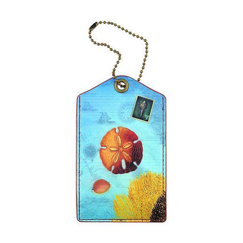 Mlavi vegan leather vintage style luggage tag features whimsical sand dollar & coral illustration. A great gift idea for yourself & your friends & family. More whimsical fashion accessories are available for wholesale at www.mlavi.com for gift shop,  , fashion accessories & clothing boutique buyers in Canada, USA & worldwide.