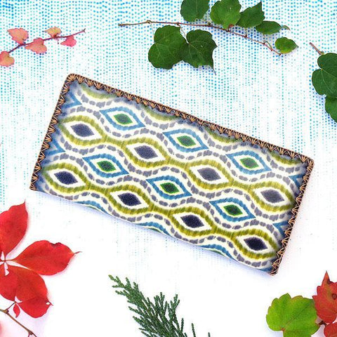 Mlavi large vegan flat wallet with whimsical & exotic Ikat pattern print & framed with decorative stitches around the edge made with cruelty-free Eco-friendly faux/vegan materials. This bohemian chic vegan wallet is fun & functional for everyday use or as gift for your family & friends who appreciate fashion accessories that makes bold statement especially for those who embrace vegan life style. 